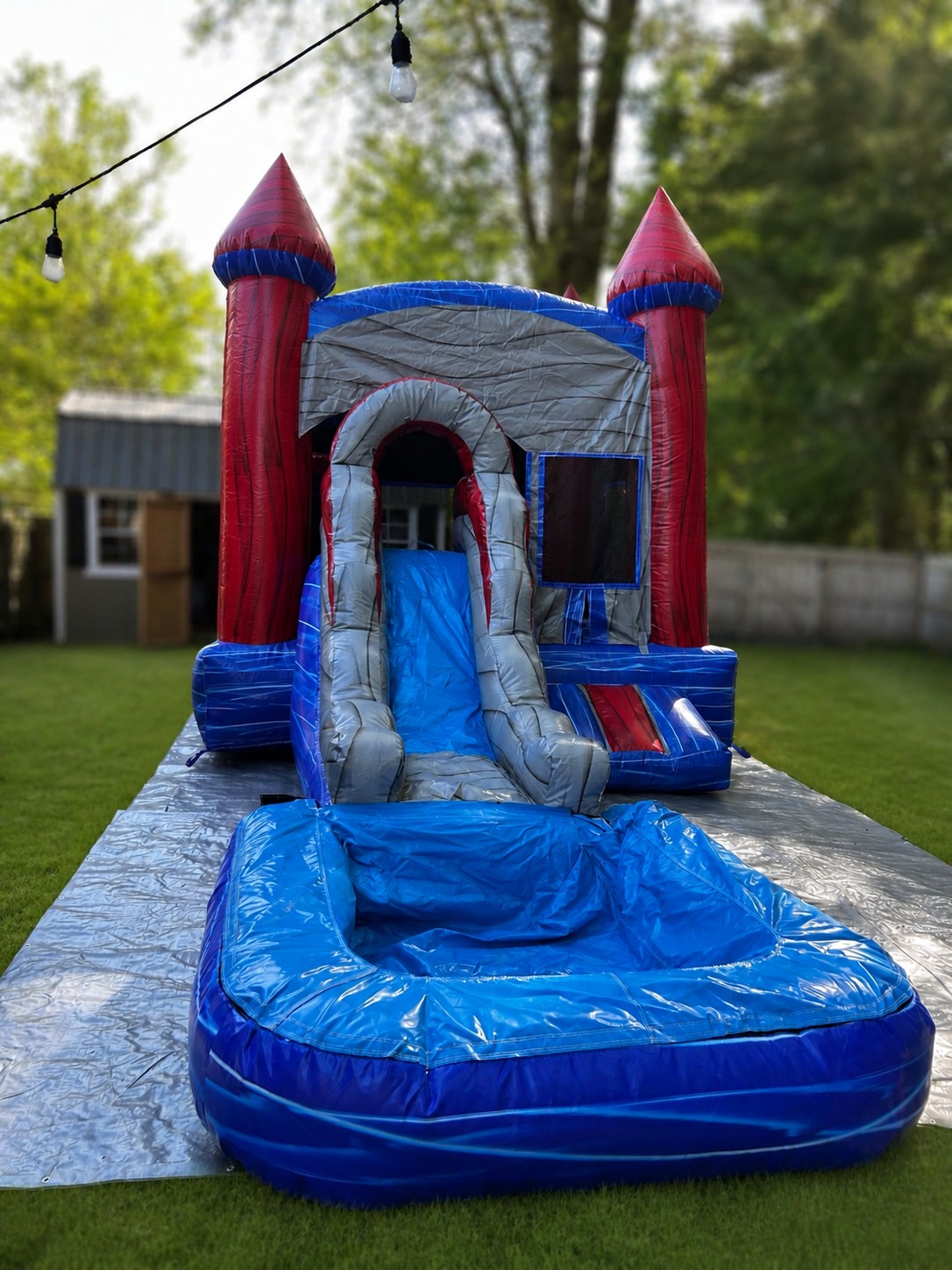 Red, white and blue bounce house combo with water slide and splash pool